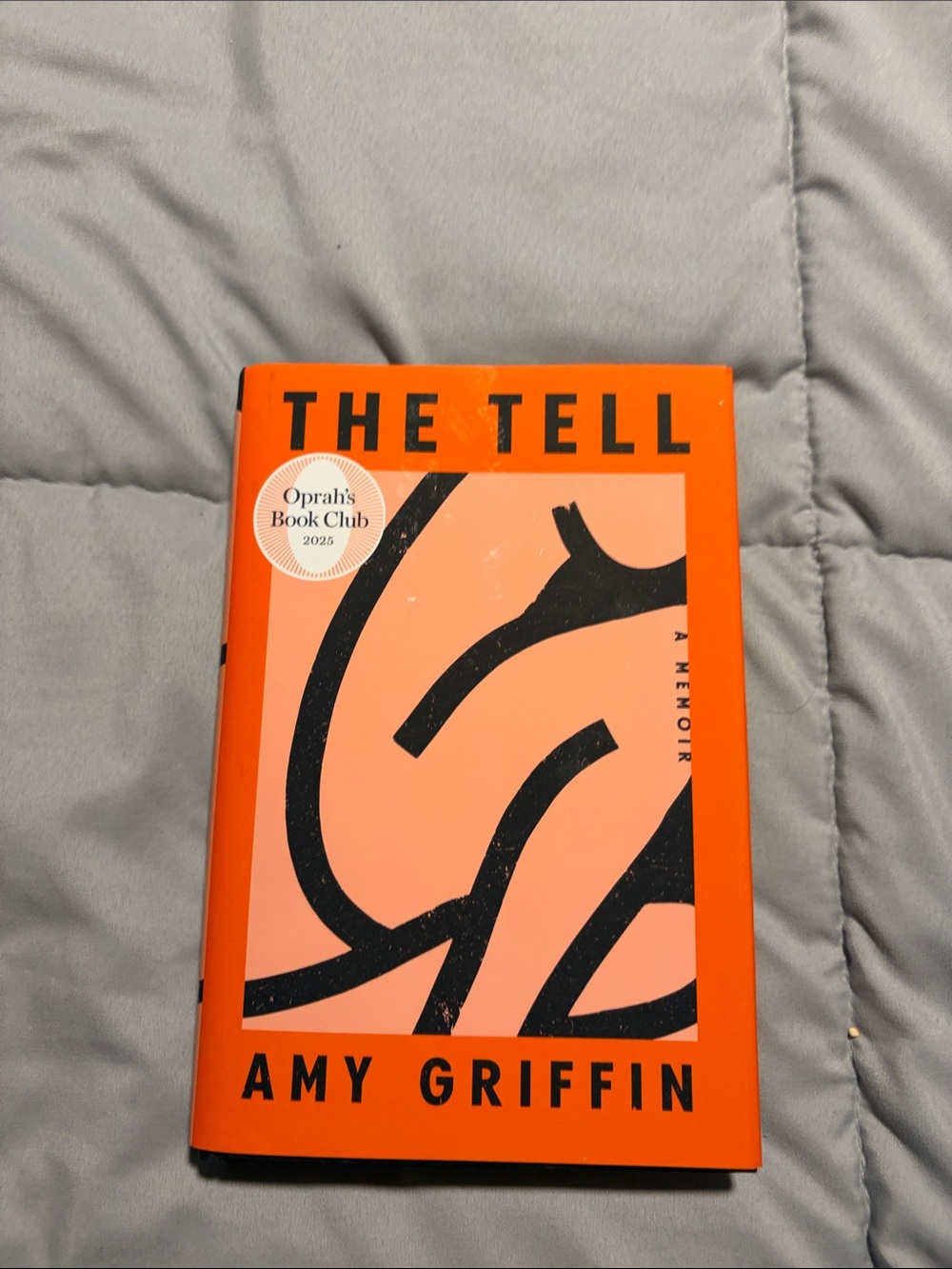 The Tell by — Orange Hardcover Edition
